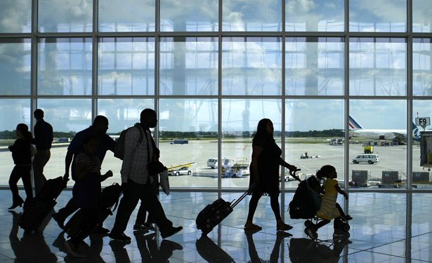 A group of people walking in an airport terminal.