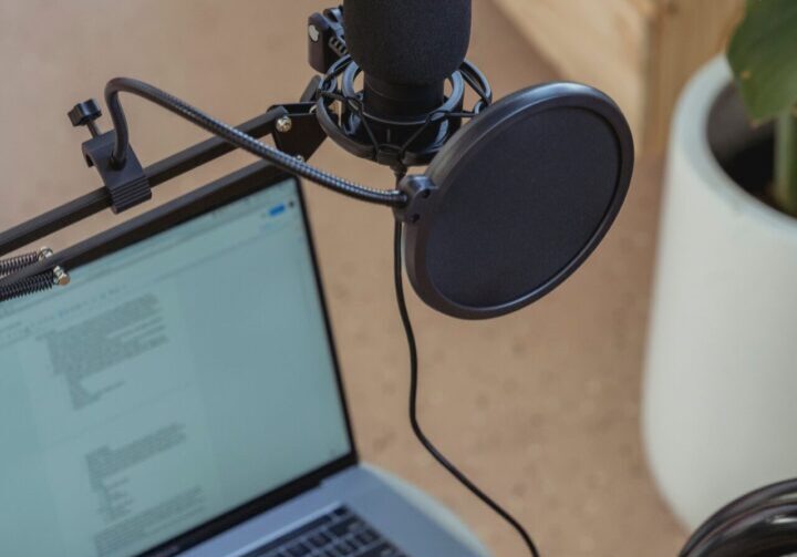 A laptop and microphone on the table
